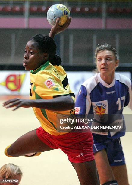 Cameroon's Jacqueline Mossy Solle tries to secore as Romania's Simona Silvia Gogorila followe her during their preliminary group D match of XVII...