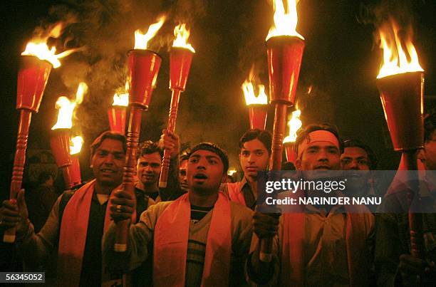 Indian activists of the Hindu Bajrang Dal Party hold torches during a procession held on the 13th anniversary of the demolition of the Babri Masjid...