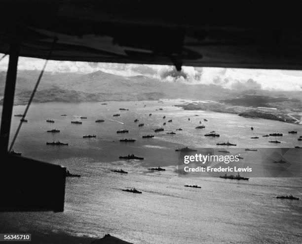 Aerial view from underneath an aircraft of a large American naval fleet at Adak Harbor in the Aleutian Islands, Alaska, 1943.