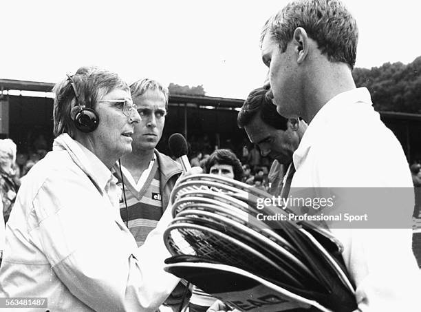 Radio commentator Gerald Williams interviews British tennis players Buster Mottram and John Lloyd of the Great Britain Davis Cup team during the...
