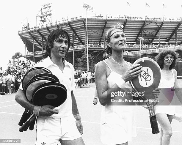 Tennis mixed doubles partner Renee Richards and Ilie Nastase leave the court after a match during the US Open Tennis Championships at Flushing...