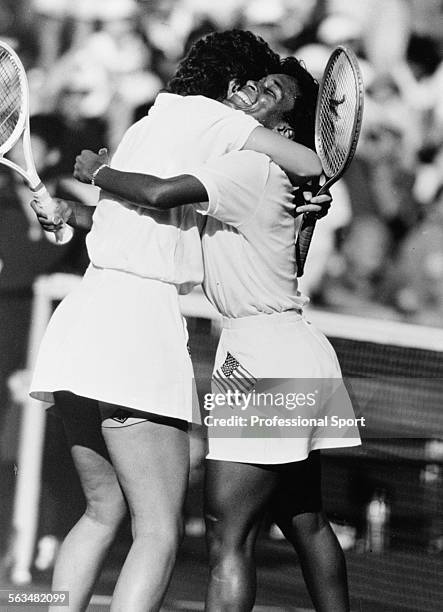 American tennis players Pam Shriver and Zina Garrison embrace after winning the gold medal in the Women's Doubles event at the Olympic Games in...