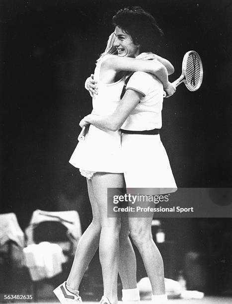 British tennis players Sue Barker and Virginia Wade embrace after winning match point in their decisive doubles match against Chris Evert and Pam...