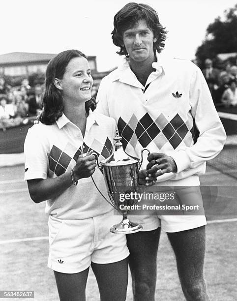 South African tennis player Kevin Curren and his doubles partner, American player Anne Smith hold their trophy after winning the final of the mixed...