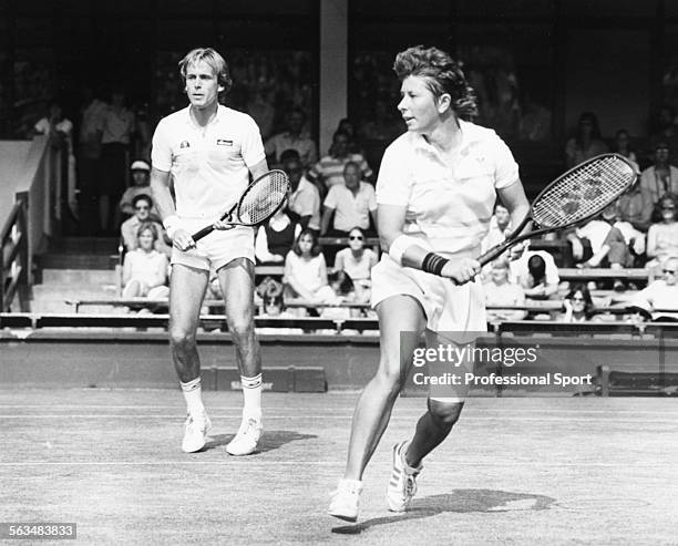 Australian tennis player Wendy Turnbull and English tennis player John Lloyd pictured together in action during a mixed doubles match at Wimbledon...