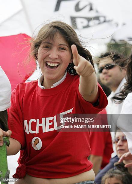 Una simpatizante de la candidata oficialista a la presidencia de Chile, Michelle Bachelet, saluda durante un recorrido de Bachelet por la comuna de...