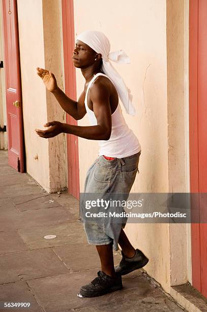 teenage boy (16-17 years) performing in street, side view - teen boy shorts stock pictures, royalty-free photos & images