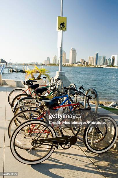 side profile of bicycles parked on a pier, san diego bay, coronado island, san diego, california, usa - coronado island stock pictures, royalty-free photos & images