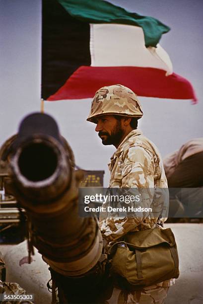 Soldier of the Inter-Arab Force in Saudi Arabia during the Gulf War, 1990. The flag of Kuwait is flying behind him.