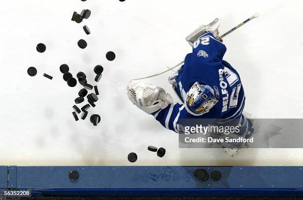 Ed Belfour of the Toronto Maple Leafs throws a pile of pucks on to the ice in preperation for facing the Los Angeles Kings on December 6, 2005 at the...