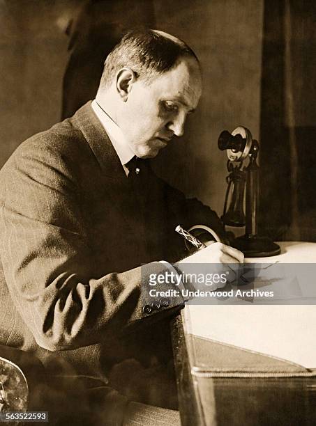 New York City Fire Commissioner Robert Adamson working at his desk, New York, New York, circa 1910.