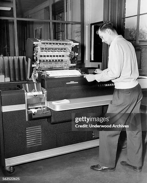 Worker using a large IBM Accounting Machine with punch cards at the Erie Railroad offices, Cleveland, Ohio, February 1951.