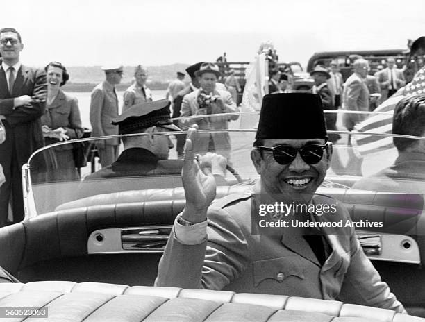 President Sukarno of Indonesia waves during a motorcade on his trip to the United States, Washington DC, May 16, 1956.