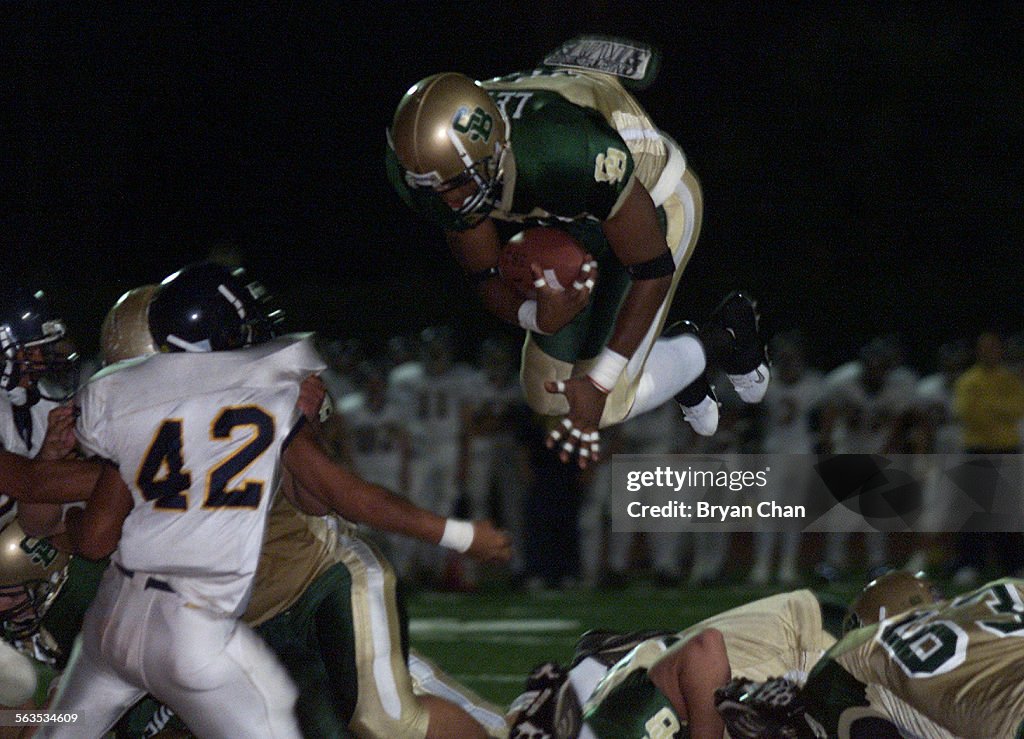 Whitney Lewis of St. Bonaventure leaps into the endzone for a touchdown against Arroyo Grande in the