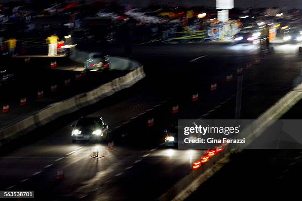 Two cars race during legal street racing at Qualcomm Stadium in San Diego on Friday, Oct. 17, 2002.