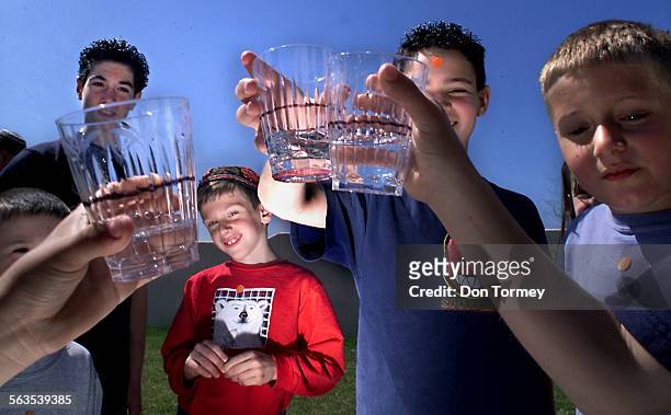 Students at the Morasha Jewish Day School in Rancho Santa Margarita, measure water in cups during an activity where children poured water for each...
