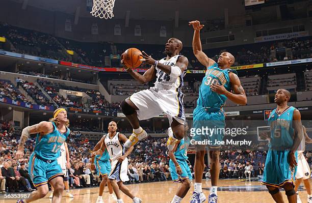 Bobby Jackson of the Memphis Grizzlies shoots a layup over David West of the New Orleans/Oklahoma City Hornets during a game between the New...