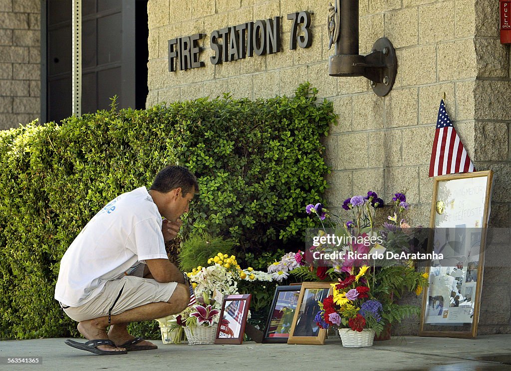 Fire fighter Dennis Garrison, from Station 10, stops to pay his respect at the memorial in front of 