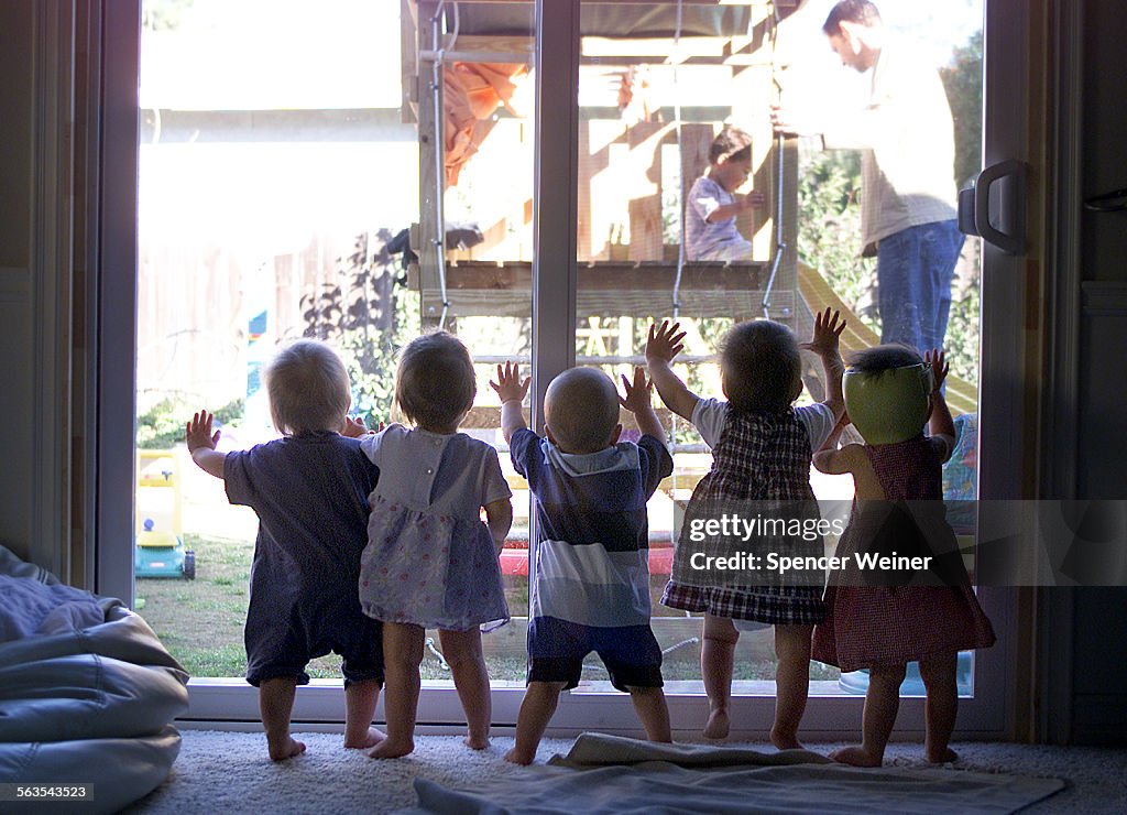 Quintuplets, Abigail, Katie, Emiline, Samuel and Nathaniel watch their older brother, brother, Ryan,