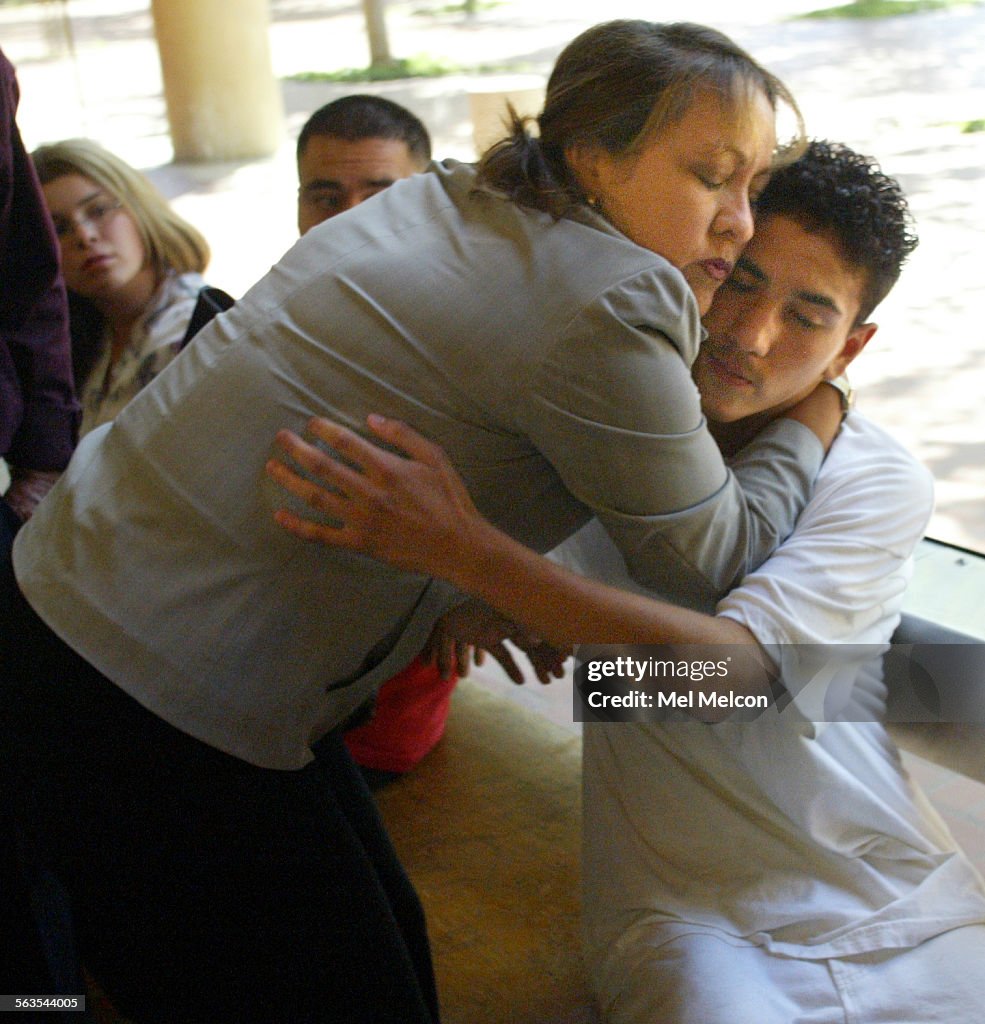 Janie Franco, sister of strangulation victim Norma Rodriguez, hugs her nephew Austin Rodriguez, son