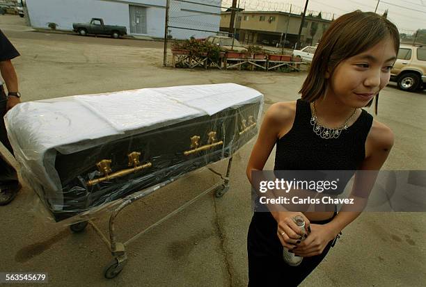 Year old Naomi Okada of las Vagas, Nv,. Picked up her casket from the maker ABC Caskets in Los Angeles Tuesday. She waits as the family's SUV in...