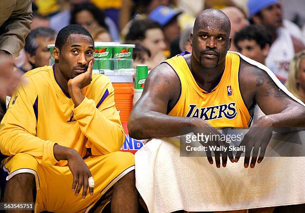 Lakers Kobe Bryant and Shaquille O'Neal sit on the bench with foul trouble against the Timberwolves in Game 6 of the Western Conference Finals at...