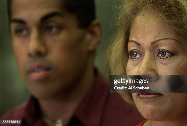 Fui Solomona, right, tears up while contemplating her husband's sixyear prison sentence handed down by judge Richard T. Toohey Friday at Orange...