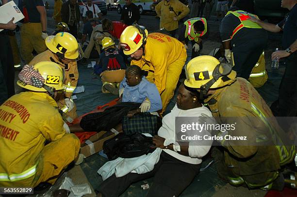 Paramedics help some of the victims of a bus crash South bound 15 HWY just north of Baker Cal. Sunday night. The tour buses where california bound...