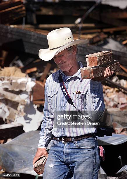 Dennis Copas 55, carries away souvenir bricks from the site where the former BanDar nightclub was being razed. Copas was a regular at the club for...