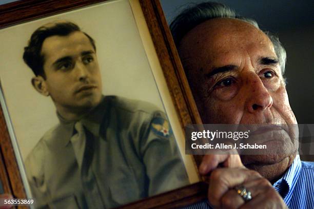 Veteran Bernard Stelzer, of Laguna Woods, shown with 1944 portrait of him wearing his Army Air Forces uniform, was gunner of the Bim Bam Bola bomber...