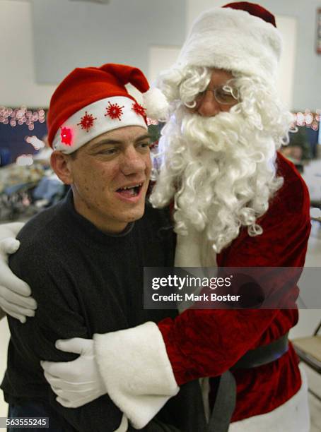 Fairview Developmental Center client Mark Bivens got a special hug from Santa Claus after Sunday Mass. Sunday Mass takes on a special meaning at the...