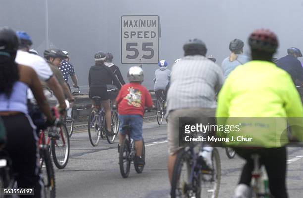 Hundreds of bicyclists, gathered in South Pasadena, take a foggy morning ride on the 110 Pasadena Freeway, also known as the Historic Arroyo Seco...