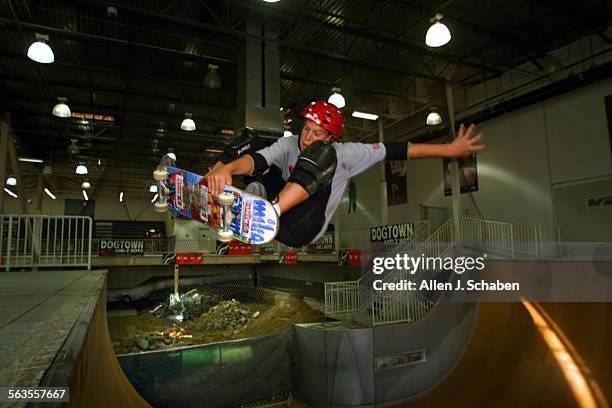 Josh Borden of Orange, goes airborne off the 12foot vert ramp Wednesday, as rubble lies from the old skate pool in the background, making way for a...