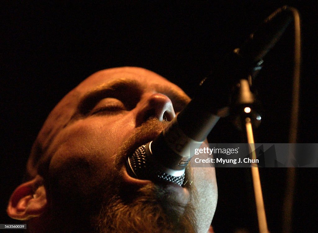 Bassist Nick Oliveri of the Queens of the Stone Age engulfs the microphone during Saturday night's p