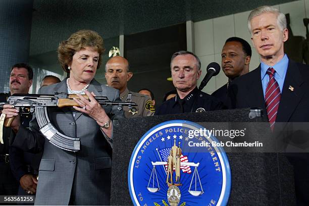 Senator Diane Feinstein holds AK47 assault rifle during appearance with Governor Gray Davis and police chiefs from around the state to urge Congress...