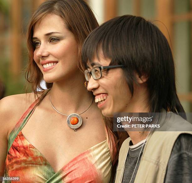 Current Miss World Maria Julia Mantilla Garcia of Peru has her photograph taken with a local fan at the Sheraton Resort in Sanya on the southern...