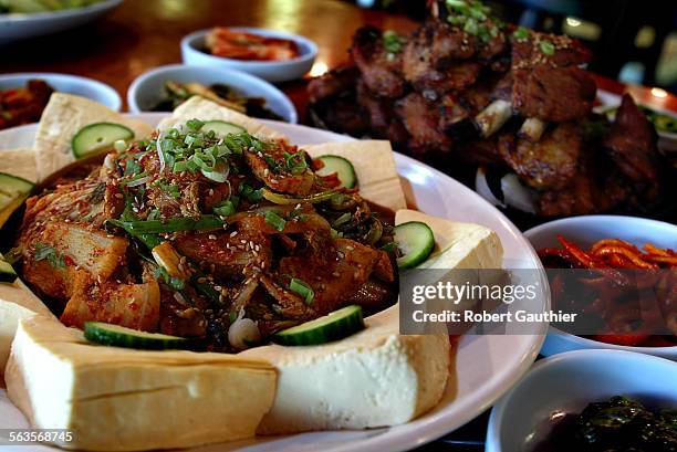 Hwa Shin Kim with her daughters Mi Mi Cho and Eun Ji Kim at their Korean Barbeque restaurant, Hamjibak in Los Angeles, Monday, July 21, 2003. Detail...