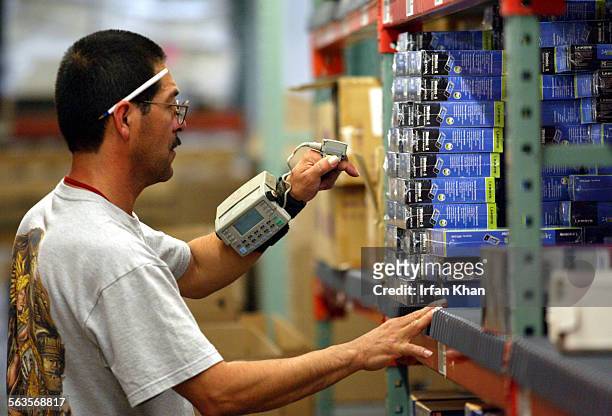 Ricardo Saenz uses finger mounted scanner while fillling an order at Ingram Micro in Mira Loma. Ingram Micro is the world's largest distributor of...