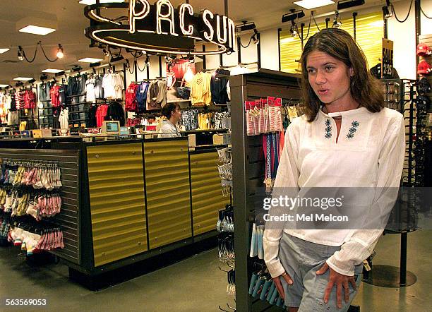 Lindsay Pelascini of Port Hueneme, looks in the mirror while trying on a peasant shirt, inside Pacific Sunwear of California located inside the Oaks...