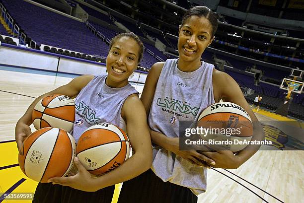 Minnesota Lynx WNBA players Helen Darling, who has triplets, and Stacey LovelaceTolbert, who has one child, posing at Staples Center holding...