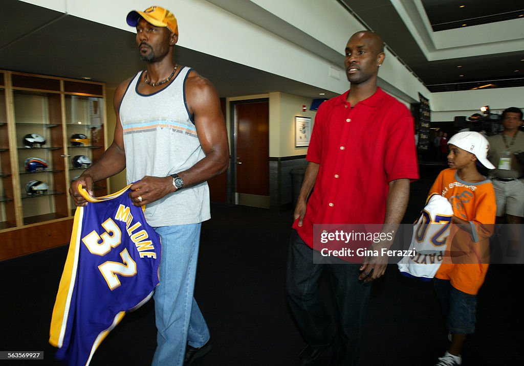 Karl Malone and Gary Payton, with his son, Gary Payton II, leave a