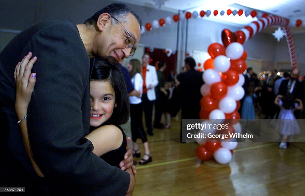 2/8/2002  Winston Bowman enjoys a dance with his 9yearold daughter, Katherine, at a community org