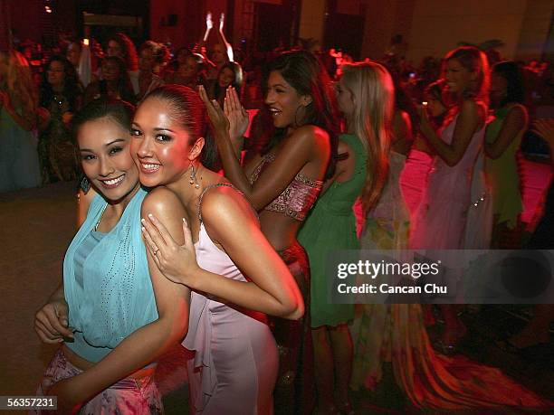 Contestants of the 55th Miss World 2005, Carlene Aguilar of Philippines and Sindie Jensen of Thailand attend a dinner party after the Beachwear Final...