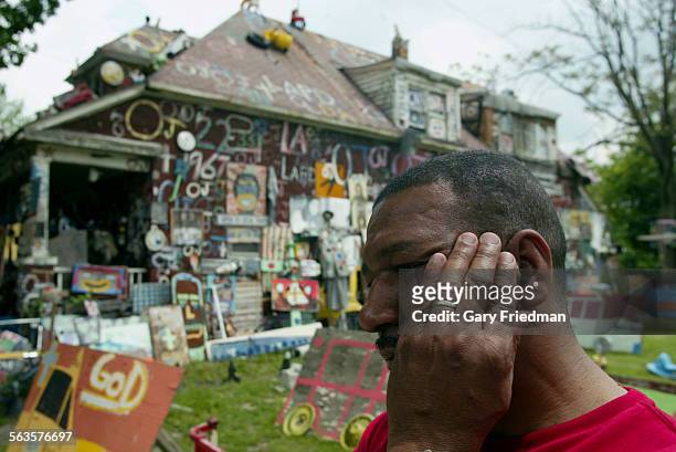 Detroit Artist TYREE GUYTON stands in front of the "OJ House" where the artwork came off of the house on Saturday, 6/7/03 and the money used at...