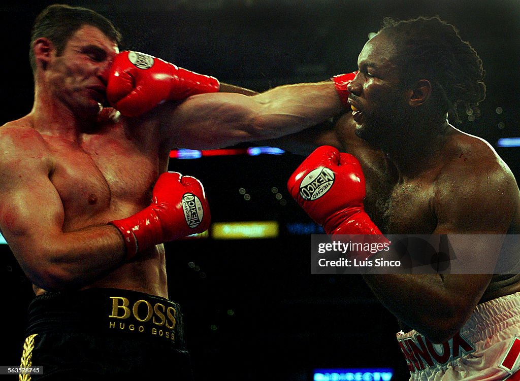 Lennox Lewis delivers a right sqaure on the nose of Vitali Klitschko in the second round of a heavyw