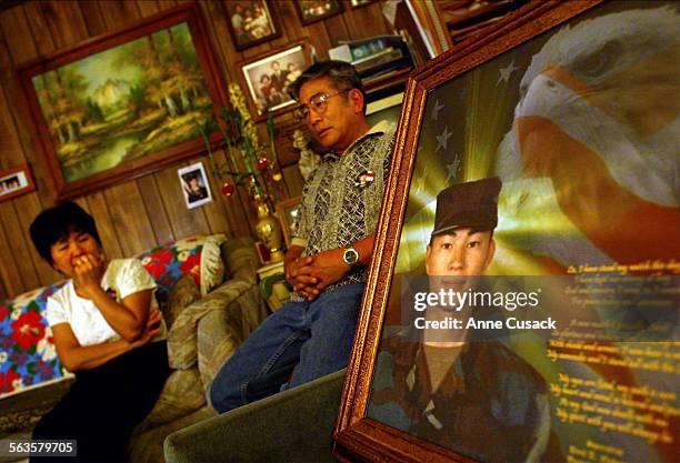 Yoko and Paul Nakamura with the portrait created by Carlos Jones from Ohio in their living room Paul Toku Nakamura was 21 when he was killed in Iraq...