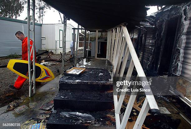 Rick Billesbach retrieves belongings from the Lake Nacimiento vacation home of his parents, which burned following the Monday 6.5 earthquake centered...