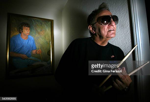 Hal Blaine one of the most famous drummers in the history of pop music, poses in front of an oil painting of himself in younger days at his home in...