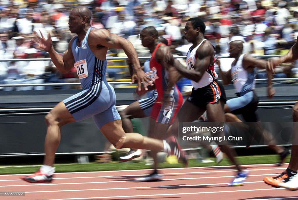 Defending Olympic champion Maurice Greene (left) pulls ahead to win the men's 100meter at the Home 