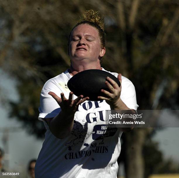 Football.AW Marcy Sutton strains to catch the ball during a drill at football tryouts at McAdams Park in Palmdale, Saturday, Jan. 10, 2004. There...